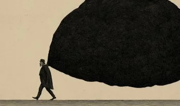 a man carrying a large black bag of coal 
