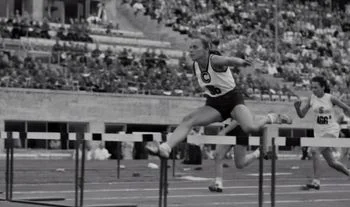 woman jumping a hurdle 