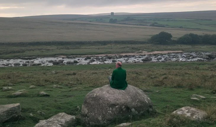 a man on a rock in the wilderness in the UK 