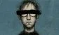 a man in glasses with a black bar of ink across his eyes